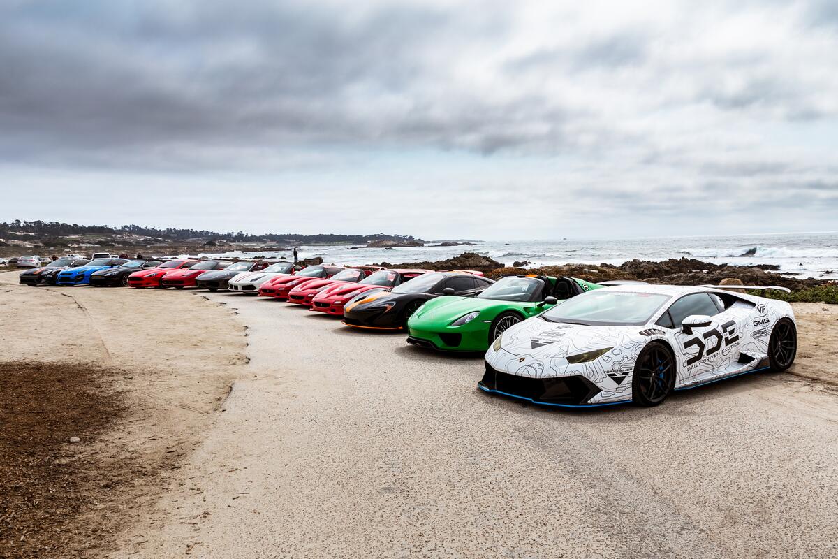 Sports cars parked on the seashore