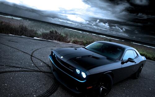 Black Dodge Challenger with black rims.