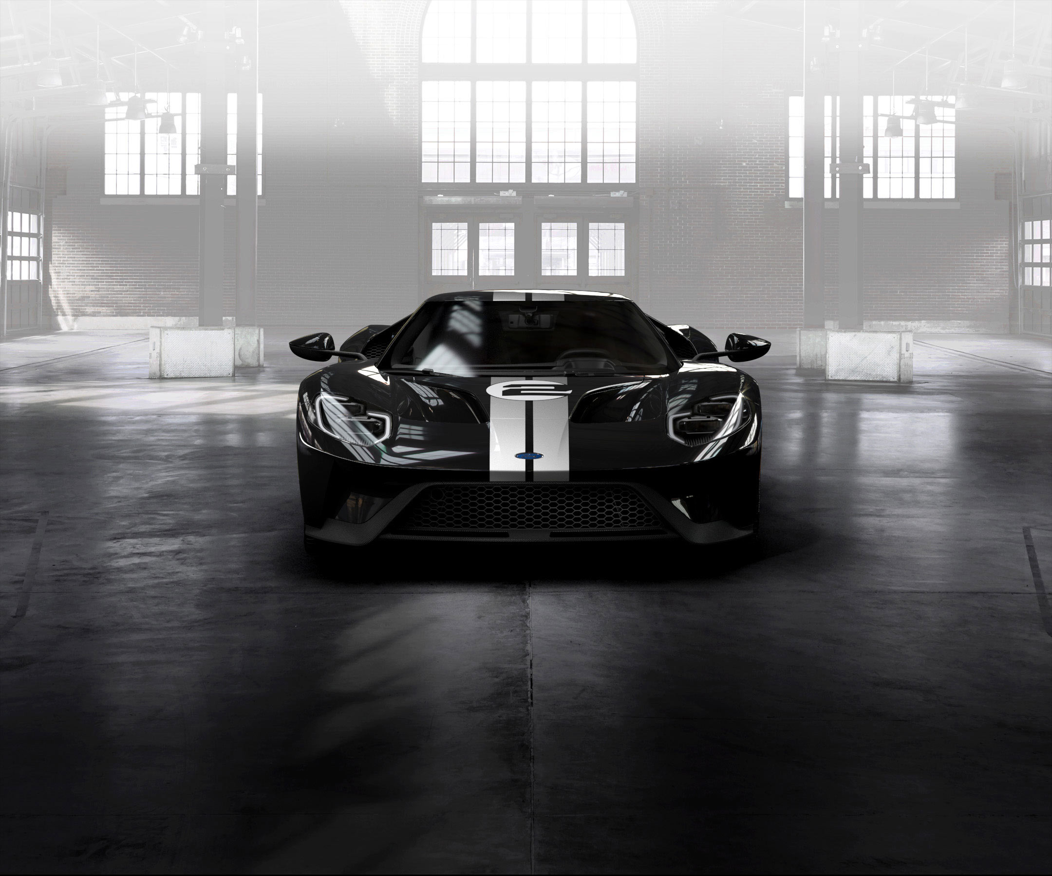 Free photo Black ford gt in a big hangar in the sunlight