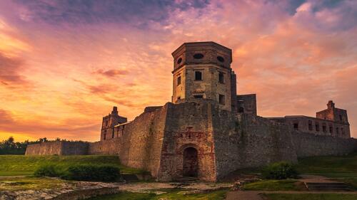 A large stone fortress at sunset