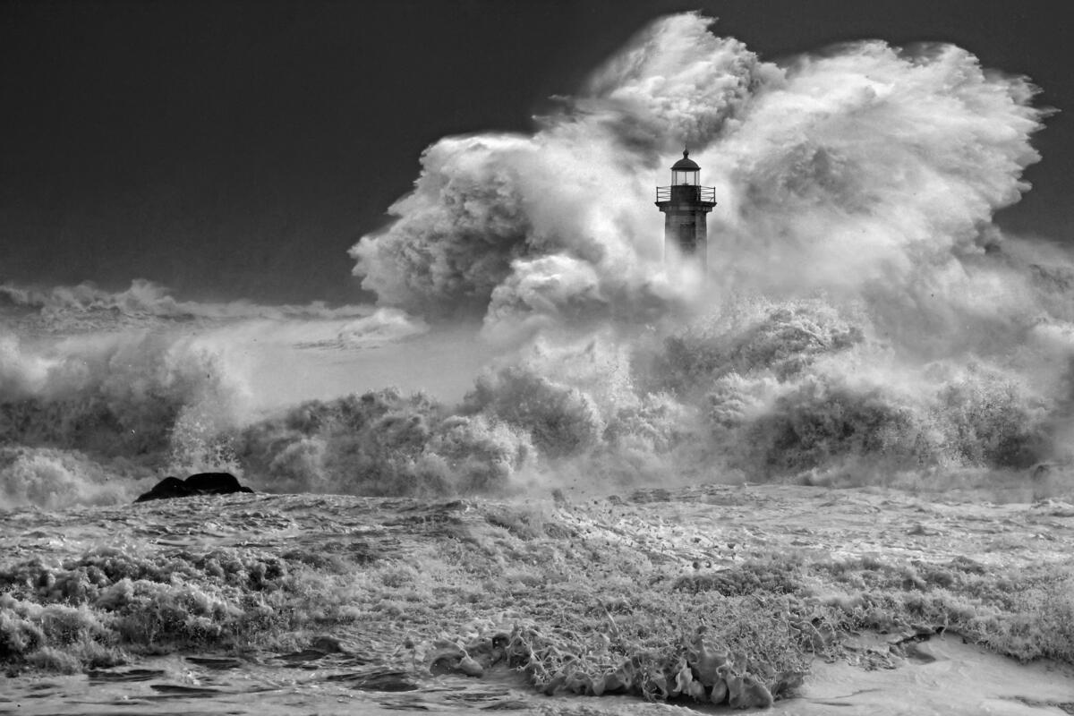 Strong waves crashing against the lighthouse