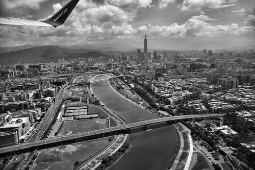 Monochrome photo with a view of the city from an airplane