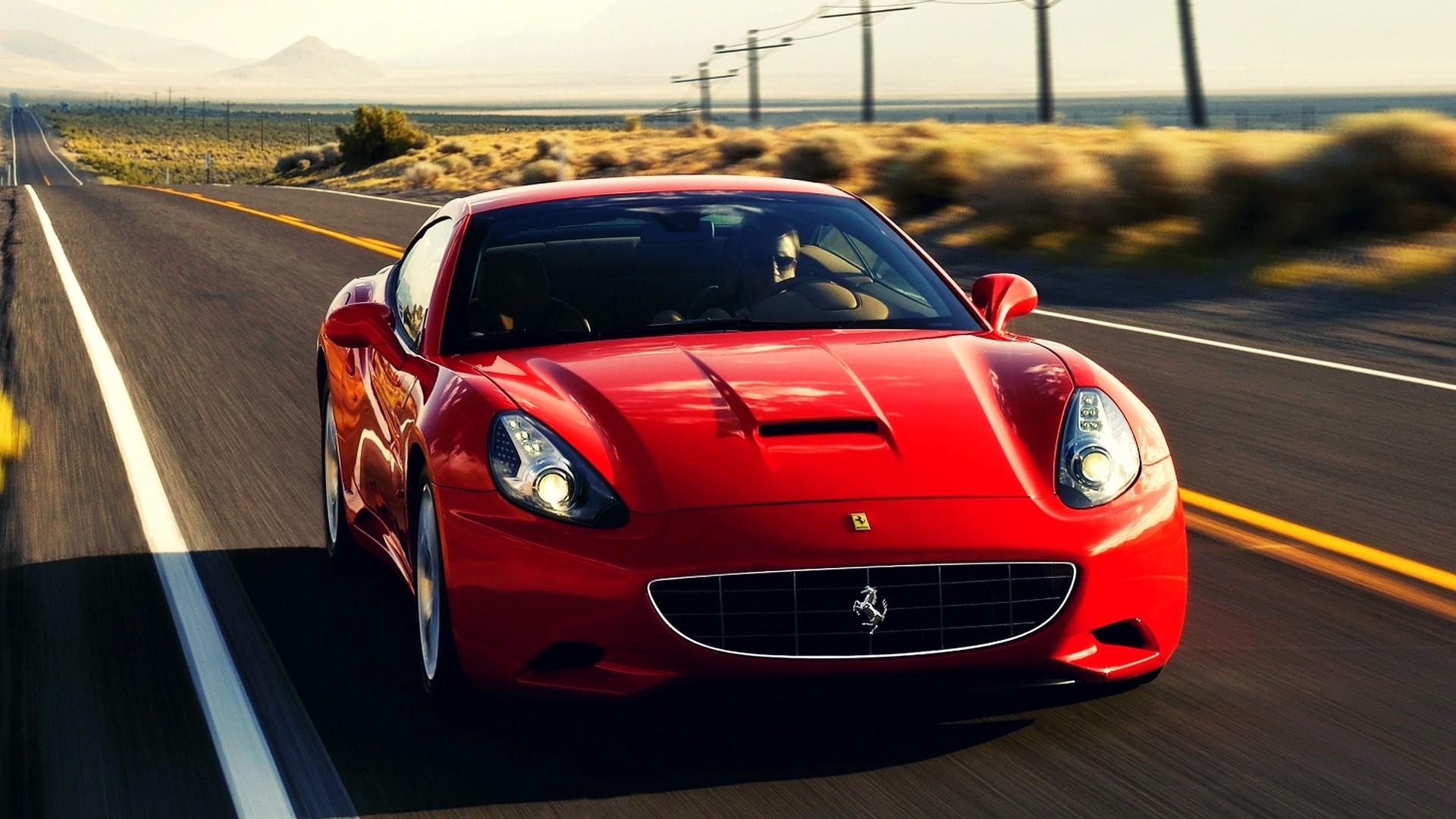 Wallpaper with a red Ferrari California on a country highway