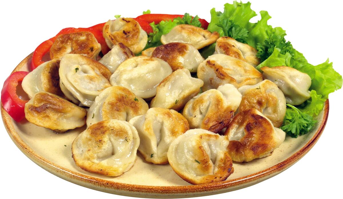 Fried dumplings with herbs on a large flat plate