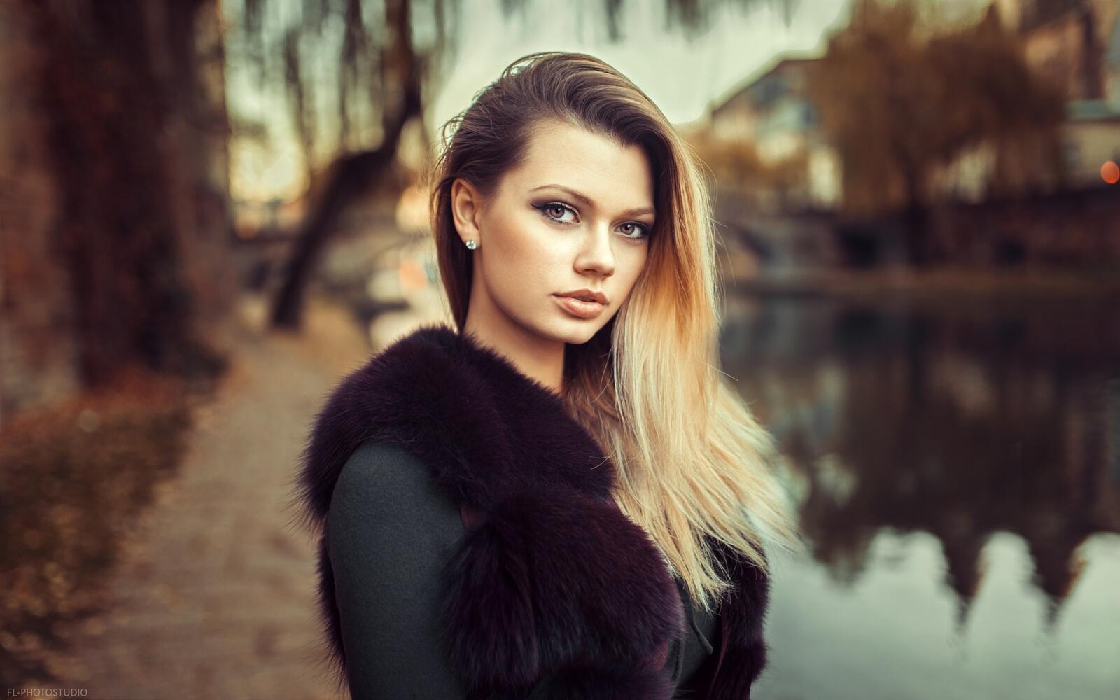 Free photo Blonde in a fur coat with long hair