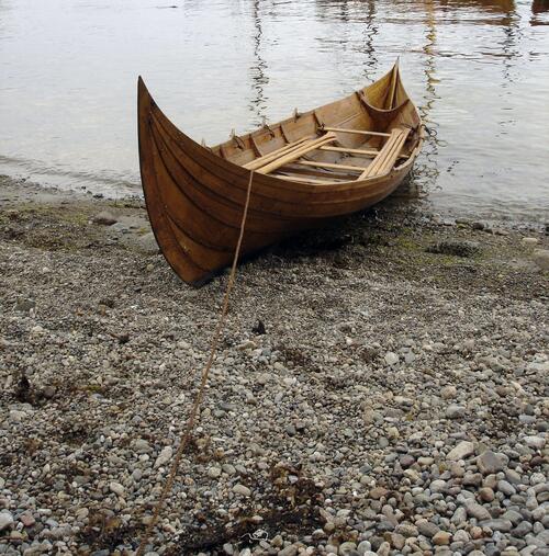 A wooden boat on the riverbank