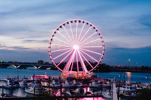 The Metropolitan Ferris Wheel is backlit in the evening