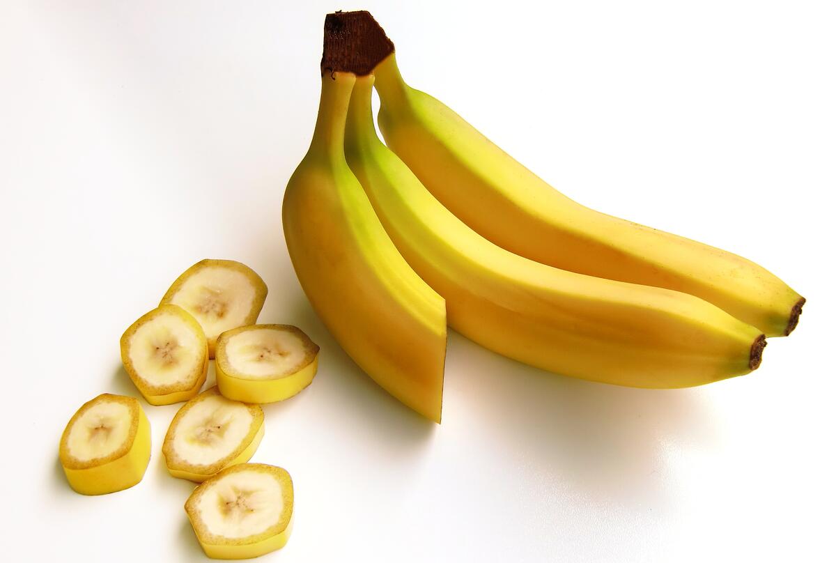 Three bananas on a light background