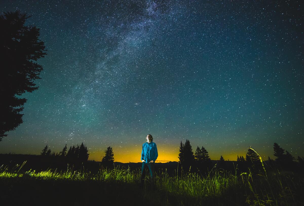 A man in a shirt watches the stars