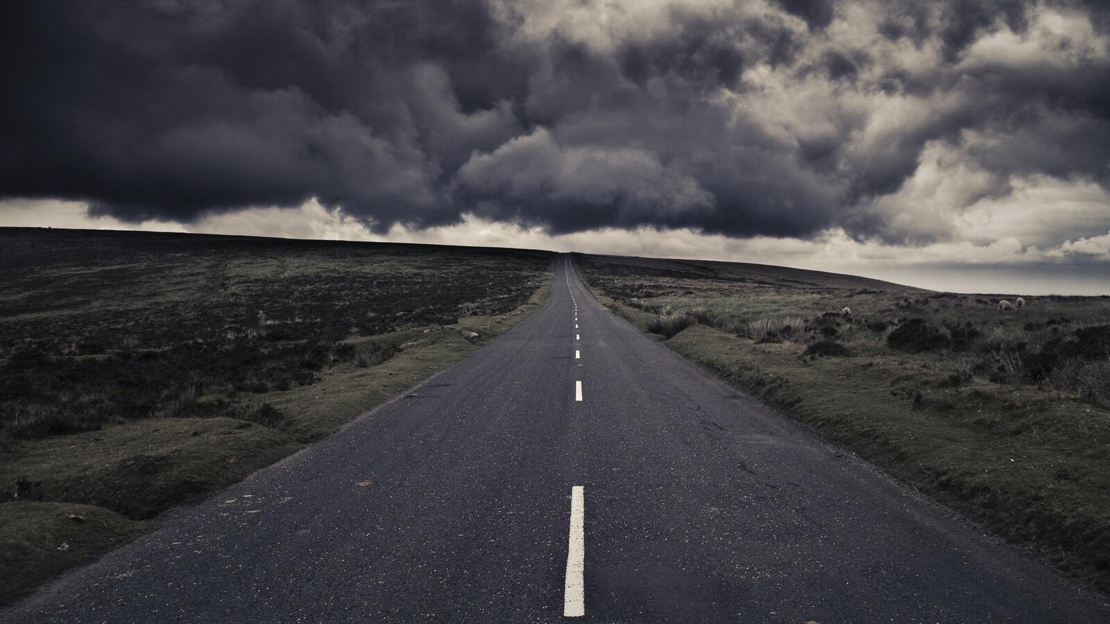 Free photo The road to the unknown under heavy clouds