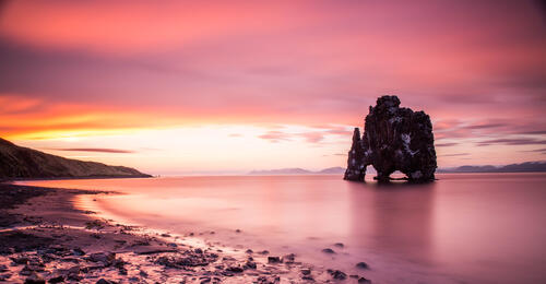 A rock formation on the coastline in Spain at sunset