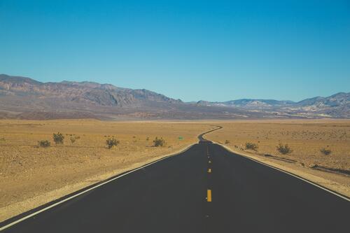 A long asphalt road in the U.S. desert