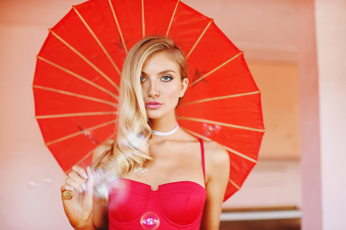 Blonde-haired Chanel Grey with an umbrella.