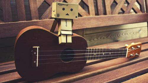 Danbo sits on his guitar