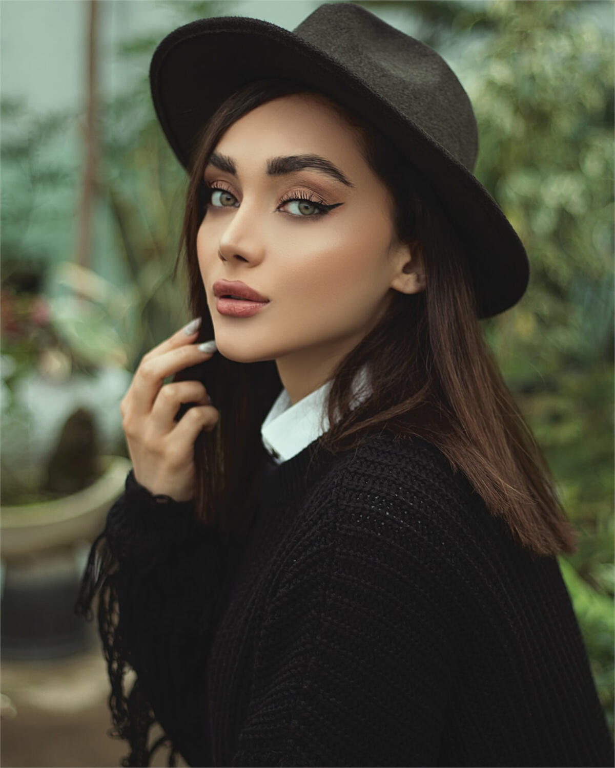 Beautiful brunette in a black hat