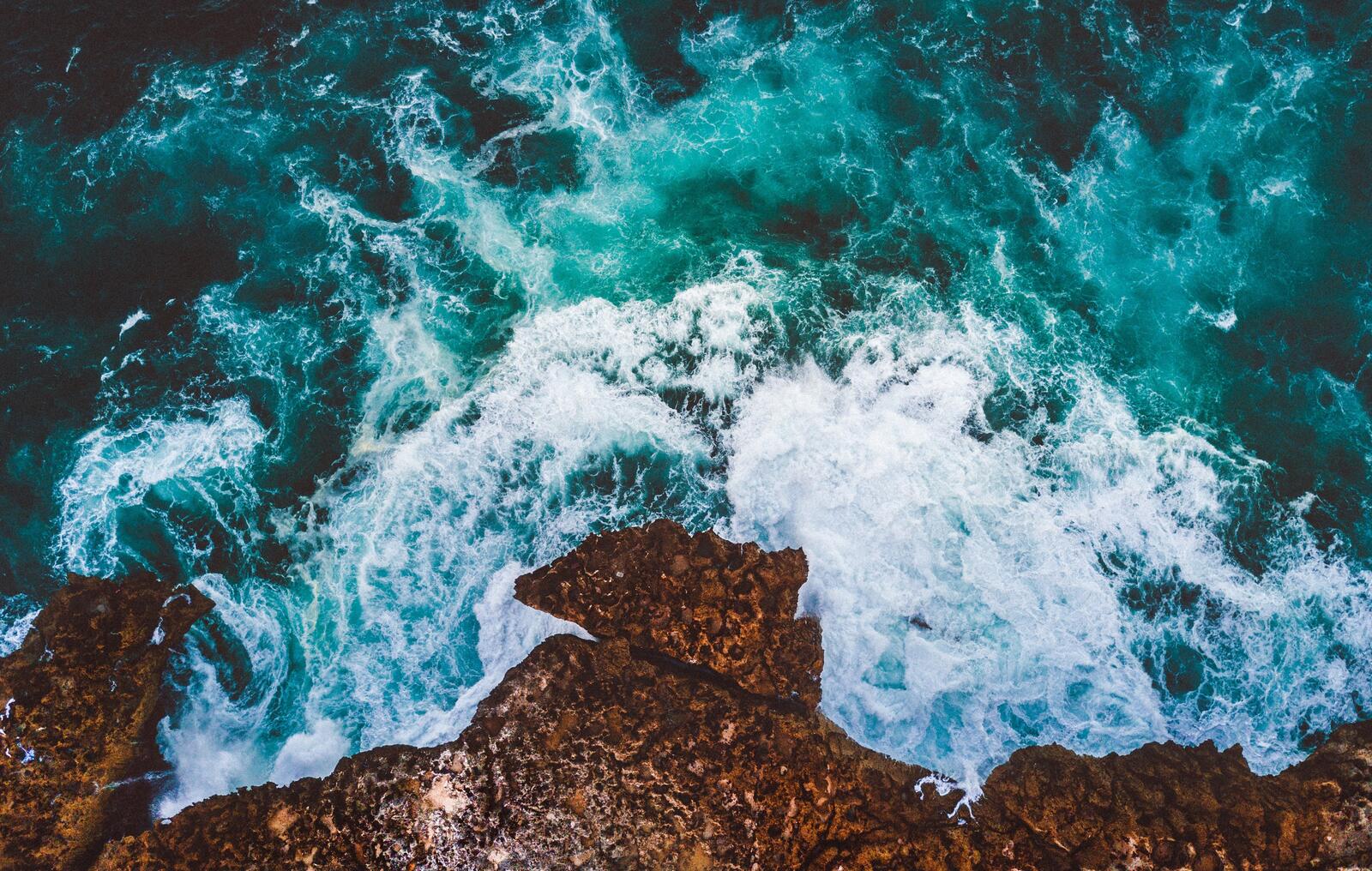 Бесплатное фото Морские волны разбиваются о скалистый берег
