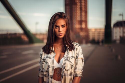 A beautiful girl in a shirt on a bridge