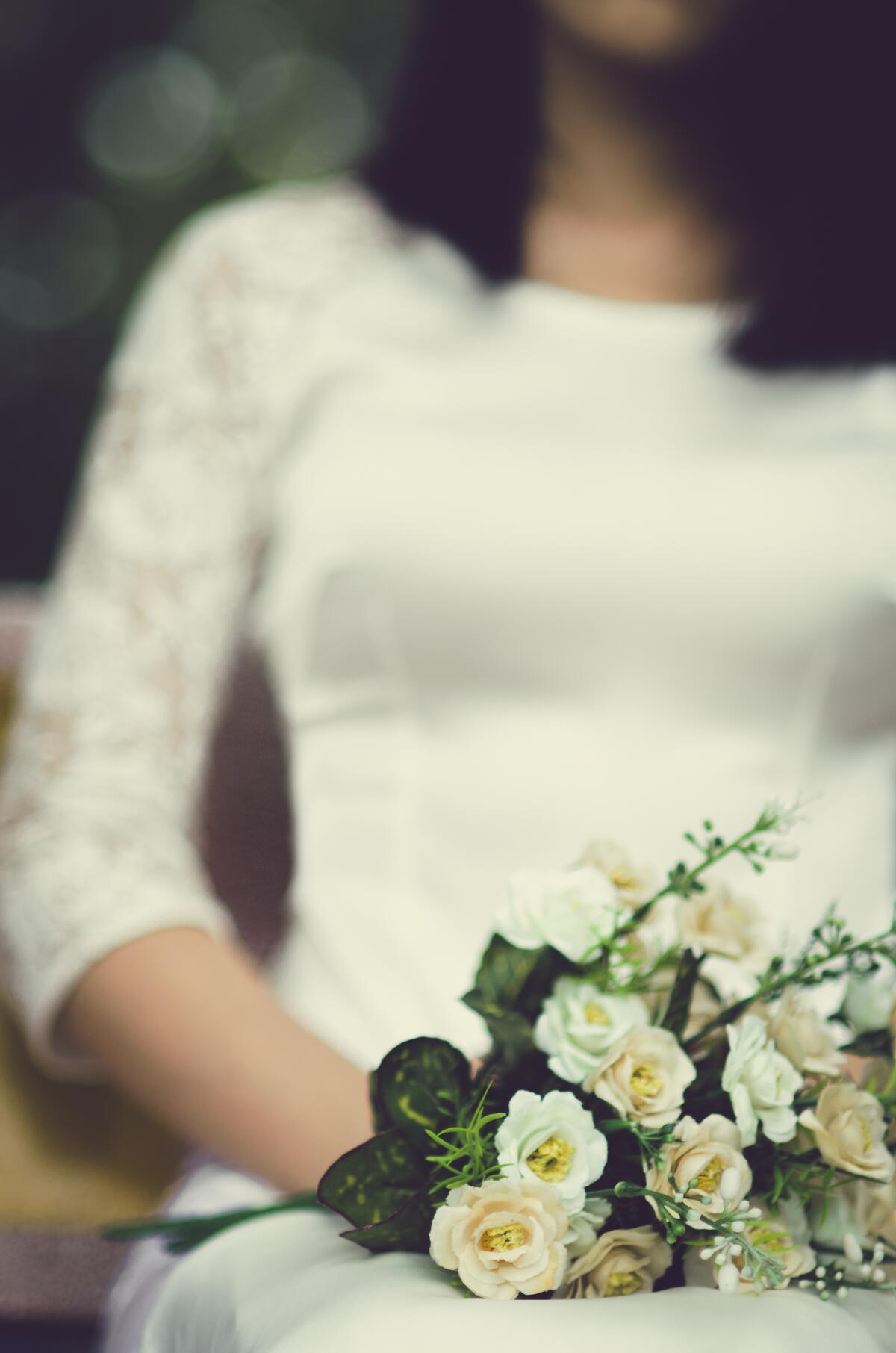 Girl in a wedding dress with a bouquet of flowers