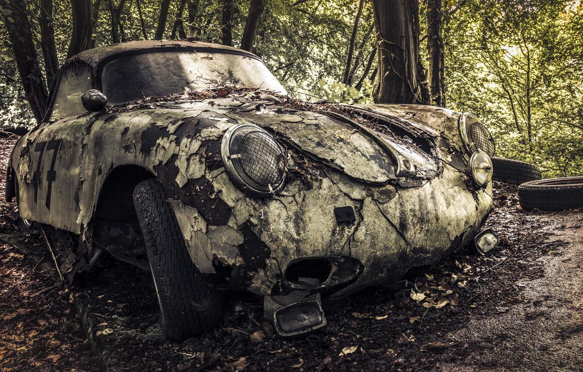 An old abandoned car covered with moss
