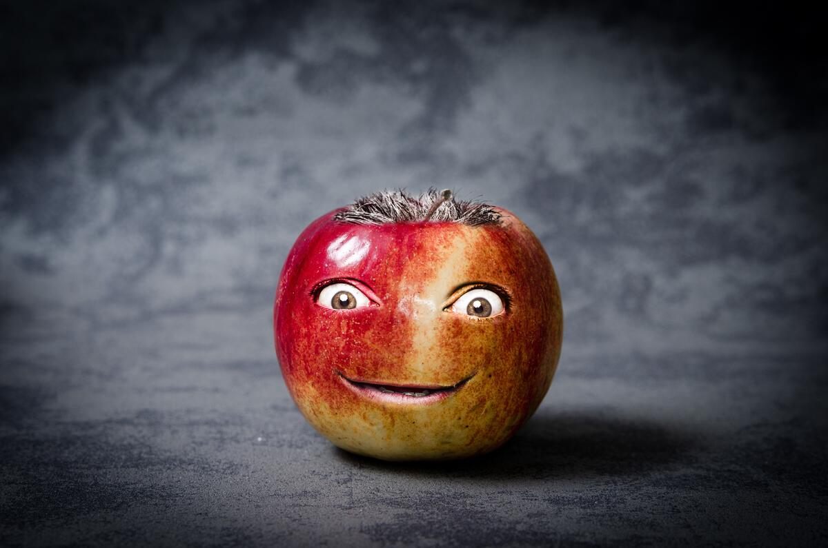 An apple with a human face on it
