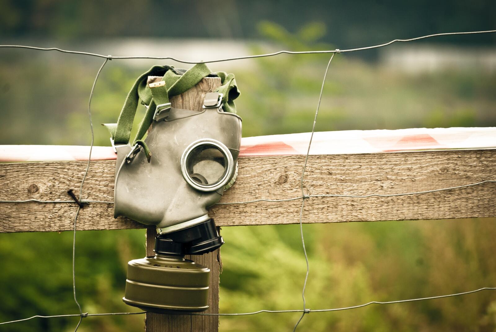 Free photo A gas mask left on the fence
