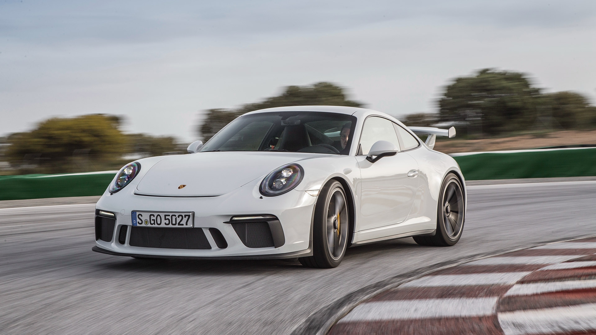 White porsche 911 gt3 rs coming out of the corner
