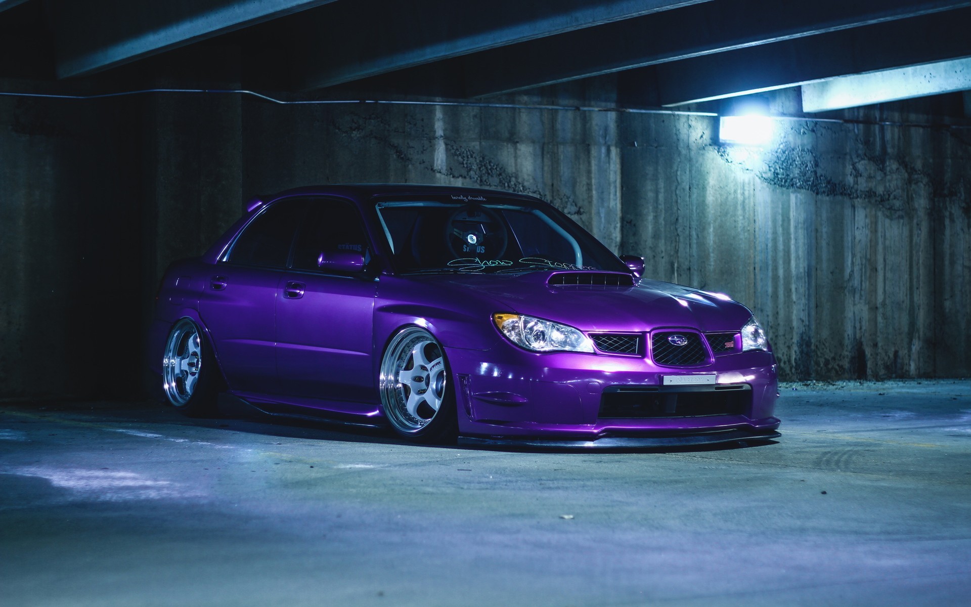 Free photo Purple Subaru in an underground parking garage.