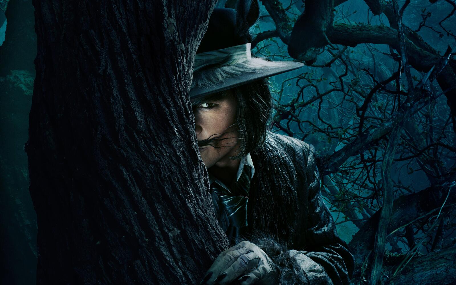 Free photo Johnny Depp looks out from behind a tree in the movie