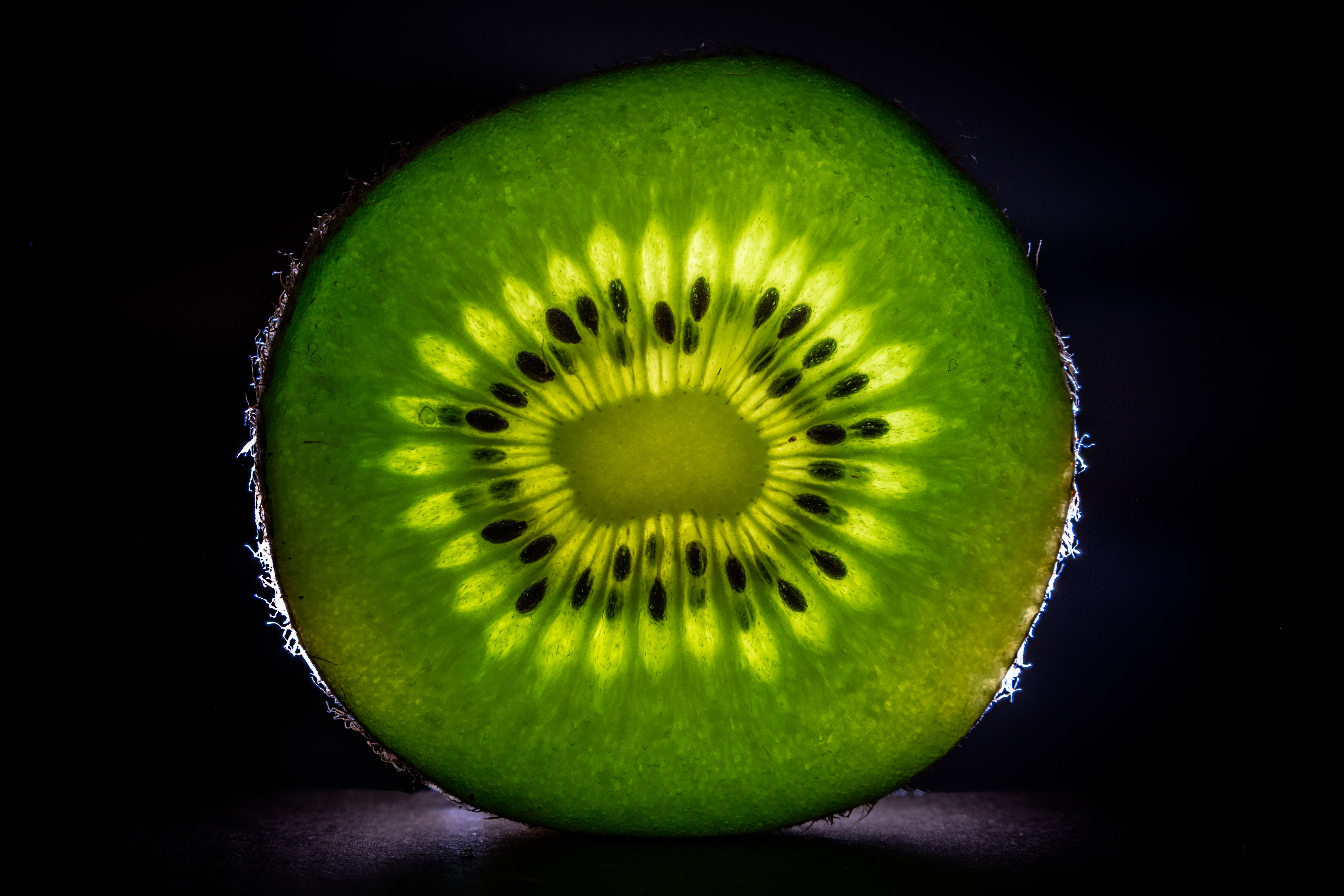 Green kiwi slice on black background