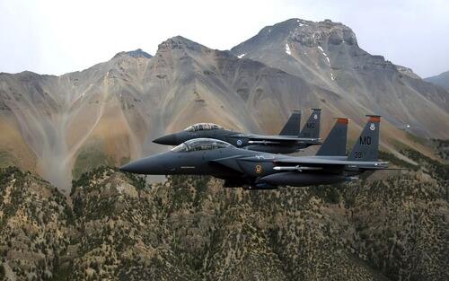 Two black McDonnell Douglas F15 Eagle fighters.