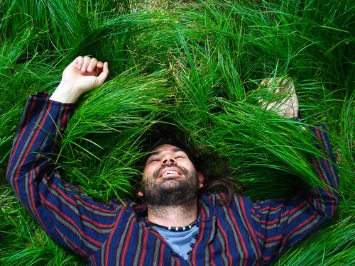 A man lying joyfully in the grass