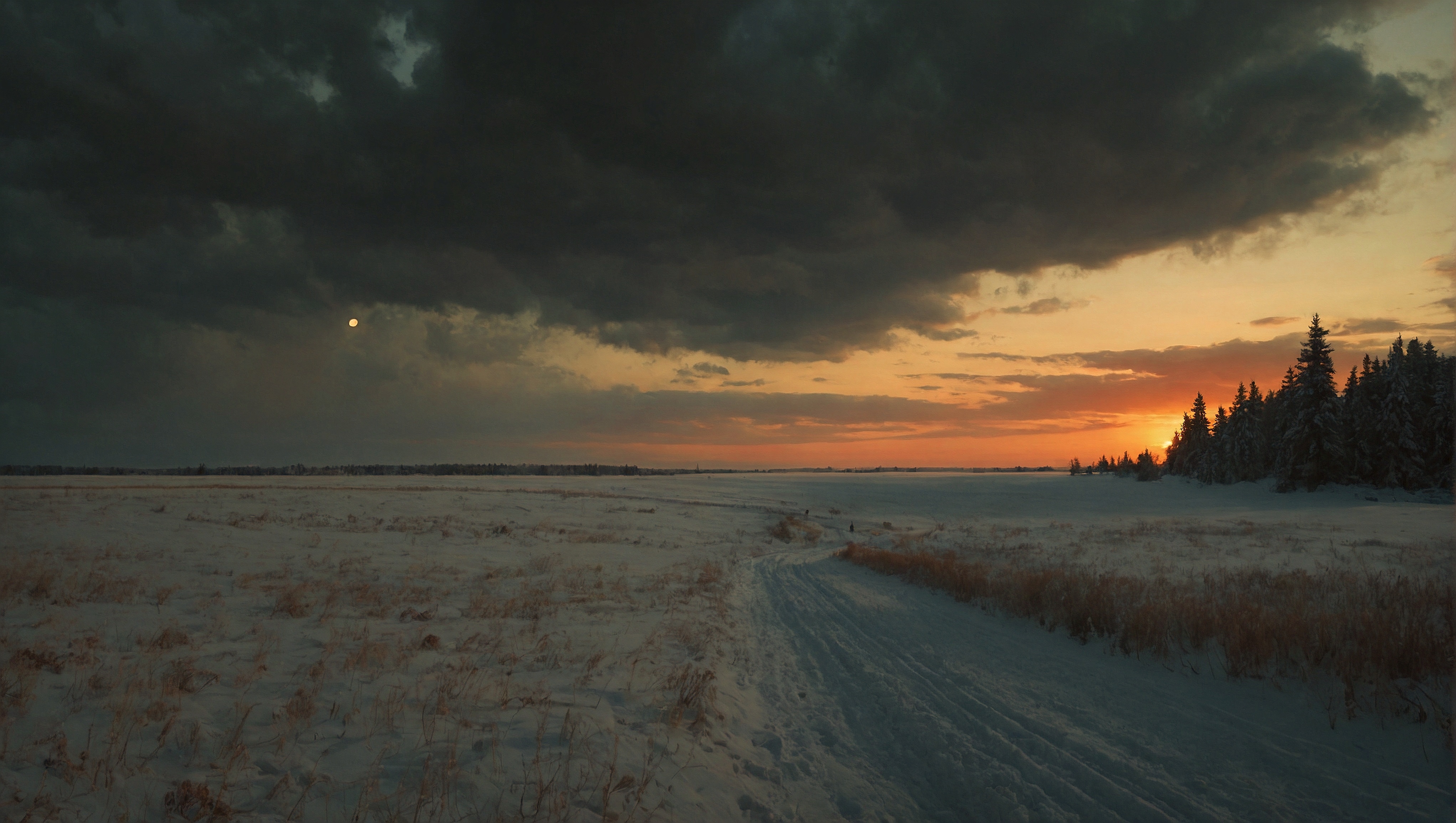 Free photo A snow covered field at sunset with dark clouds and a bright sun