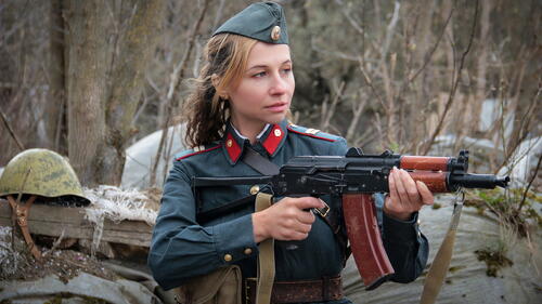 A girl militiaman firing a machine gun