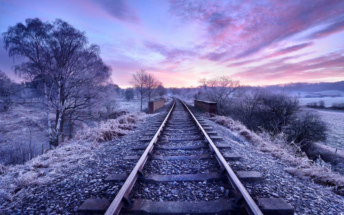 A railroad track on a frosty evening