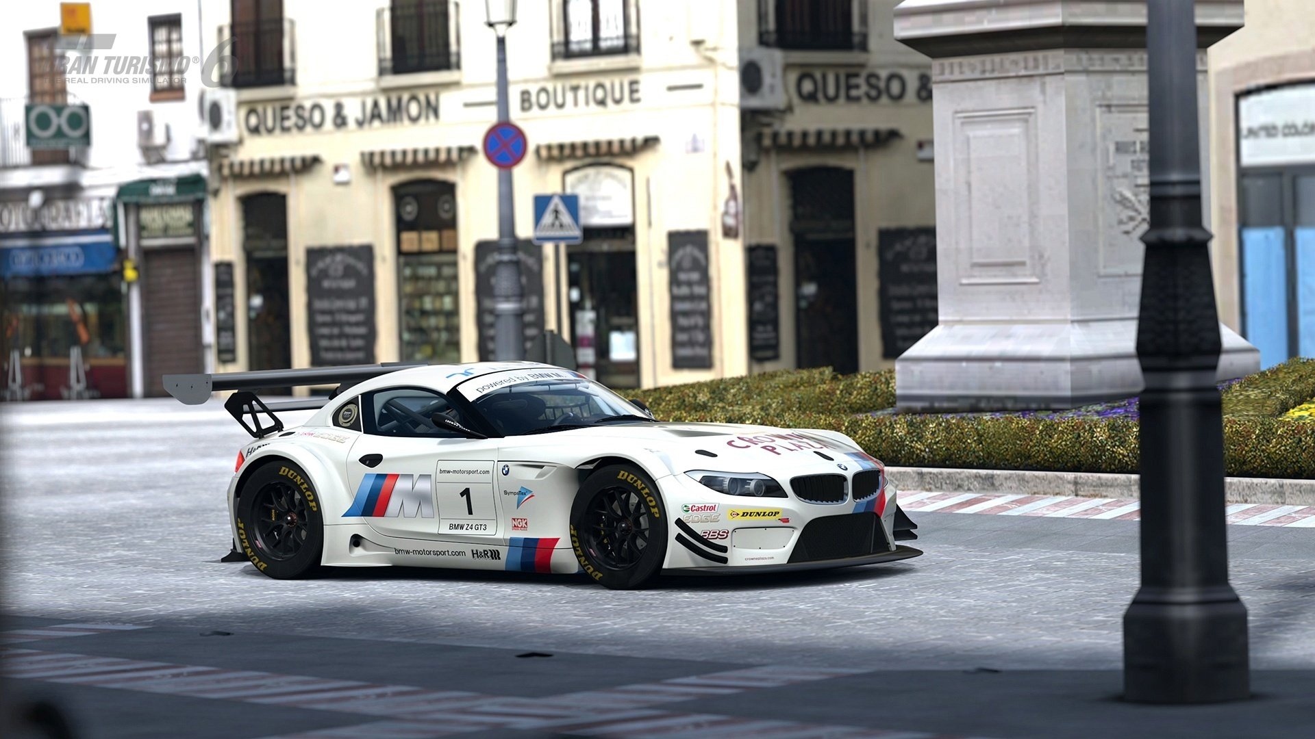 White BMW Z4 GT3 with stickers.