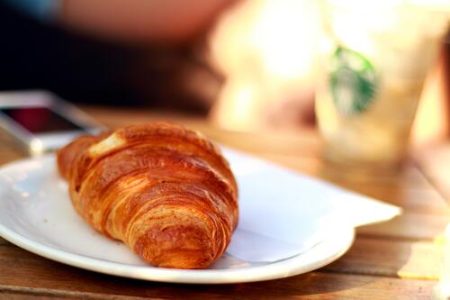 Croissant on a white plate.