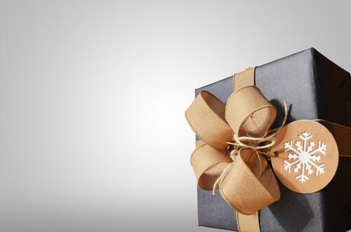 Gift box with bow on gray background