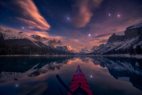 Kayaking on a night lake in Canada
