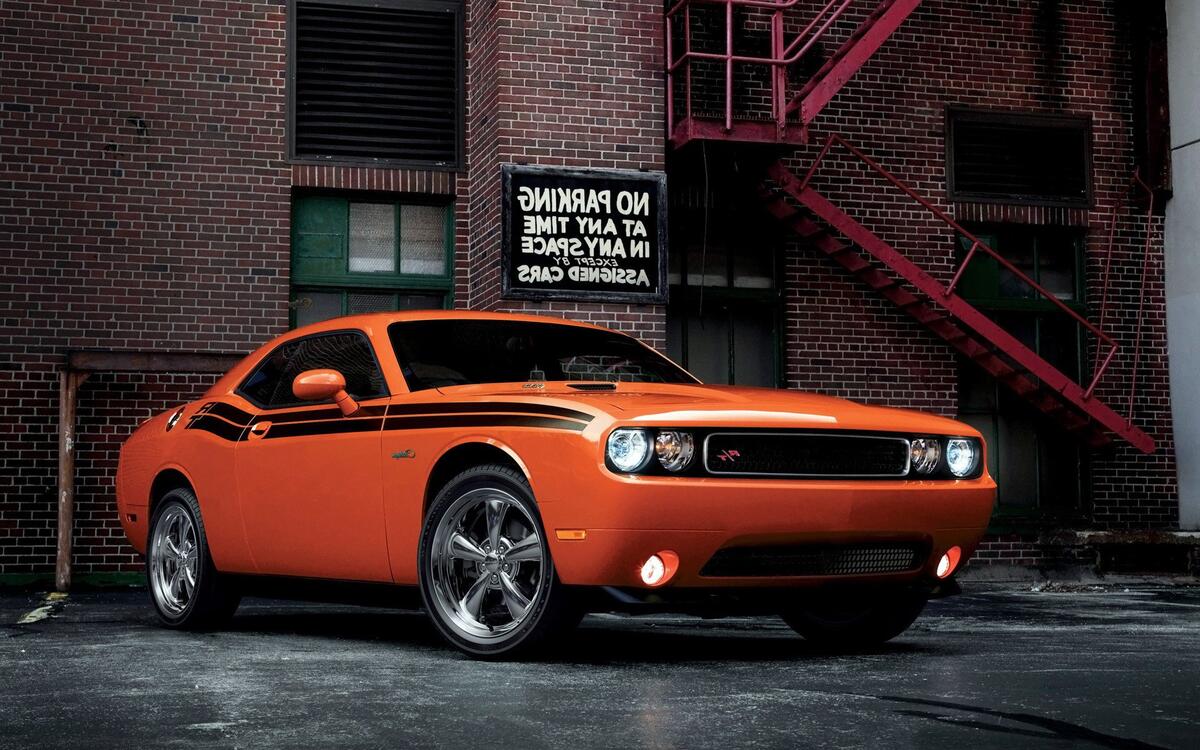 Orange Dodge Challenger with chrome rims
