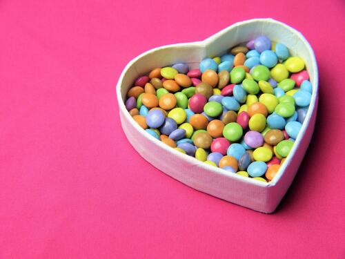 Colored candies in a heart-shaped box