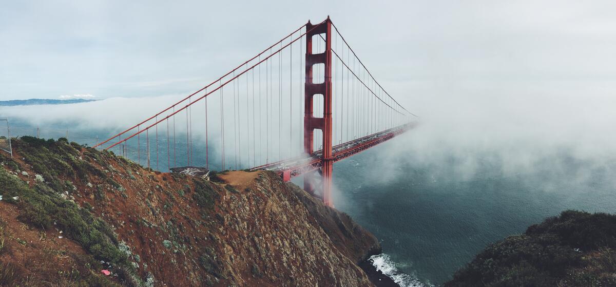 The Golden Gate Bridge breaks through the fog