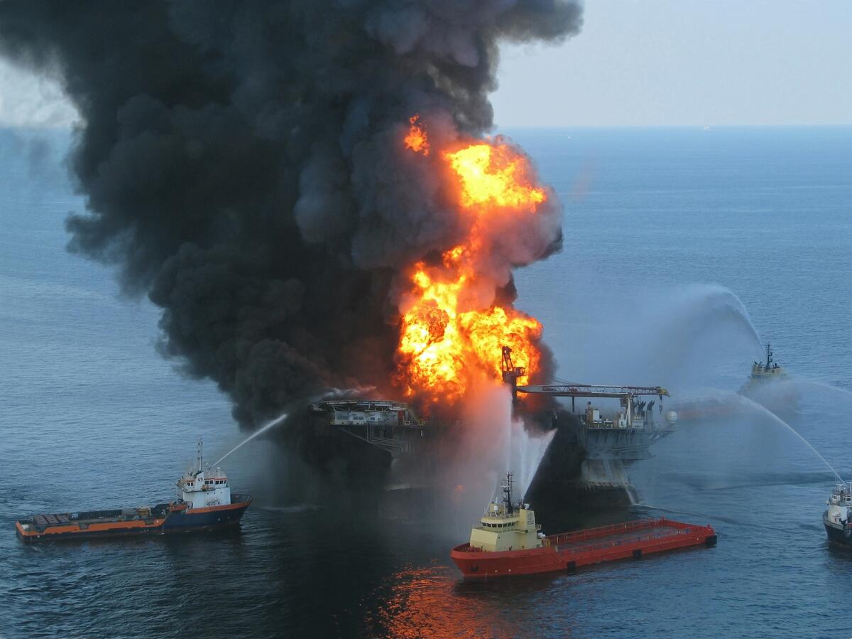 Firefighters extinguish an oil rig at sea