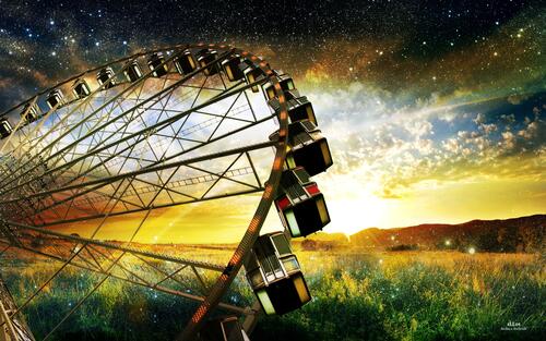 Ferris wheel against the backdrop of a fantastic evening sky