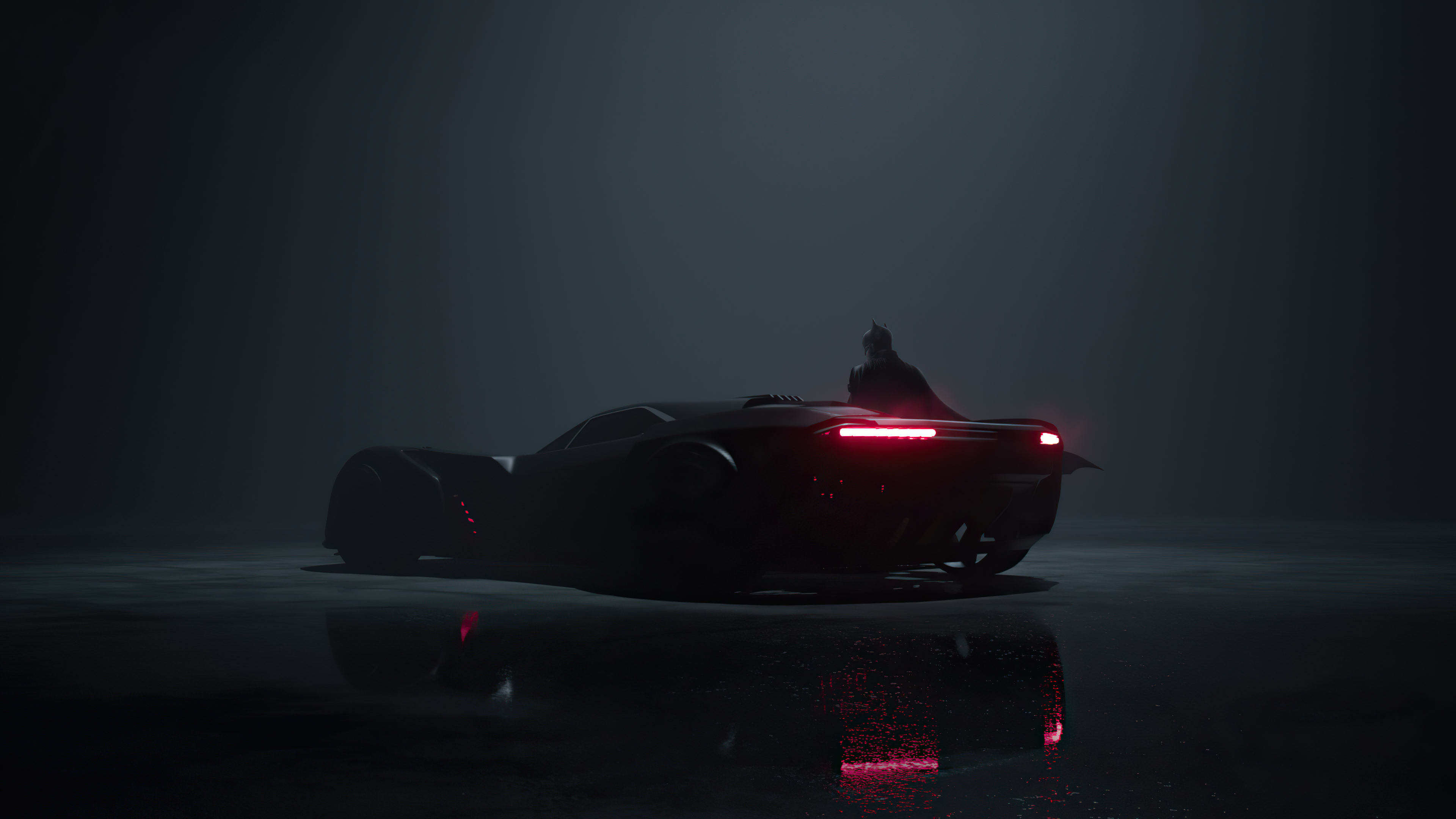 Free photo Batmobile on a dark foggy background