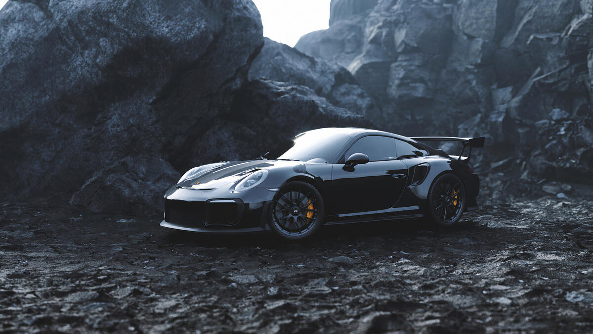 Black Porsche against a backdrop of rocks