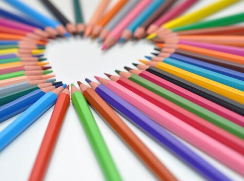 Colored pencils arranged in the shape of a heart