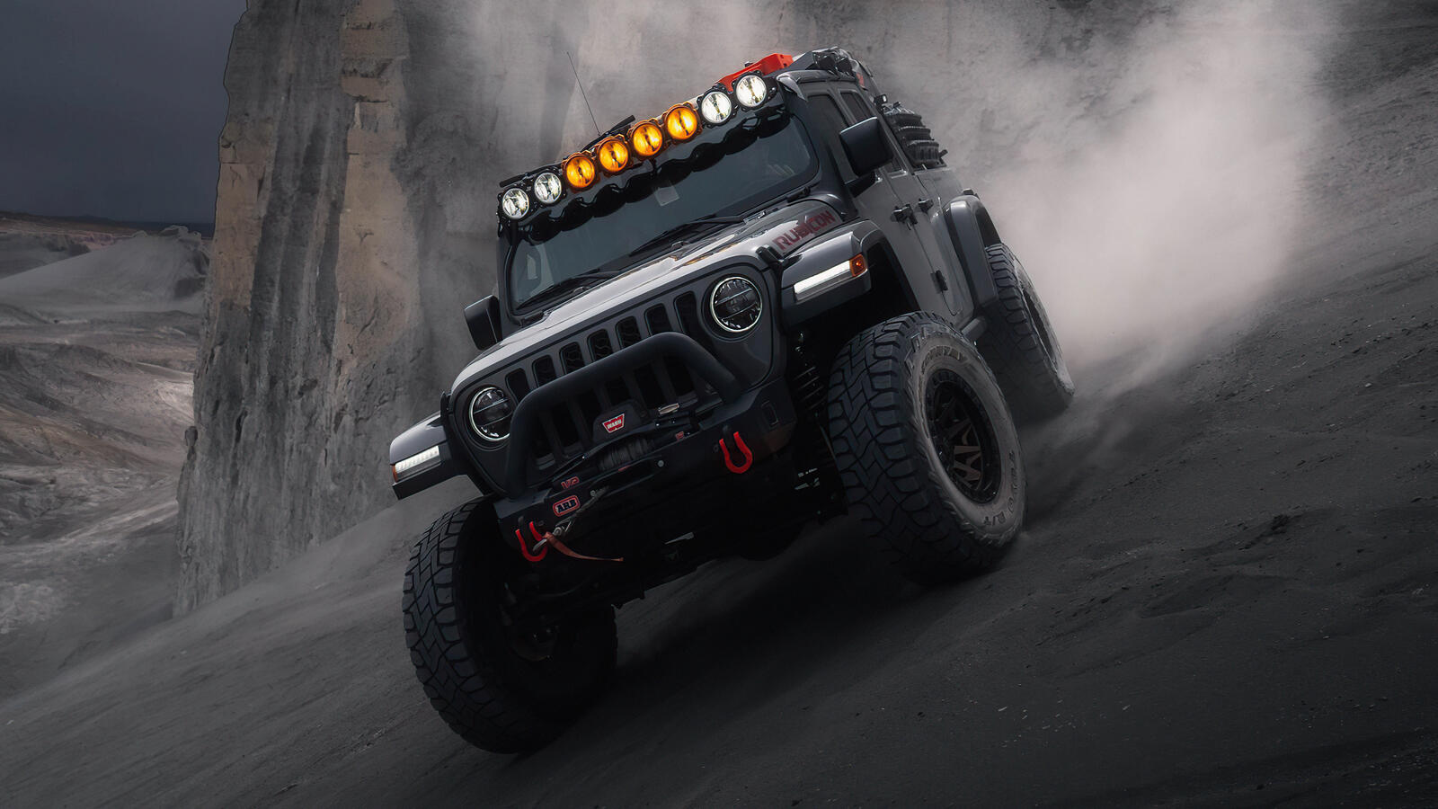 Free photo Black Jeep Wrangler in a new body is driving through the dust