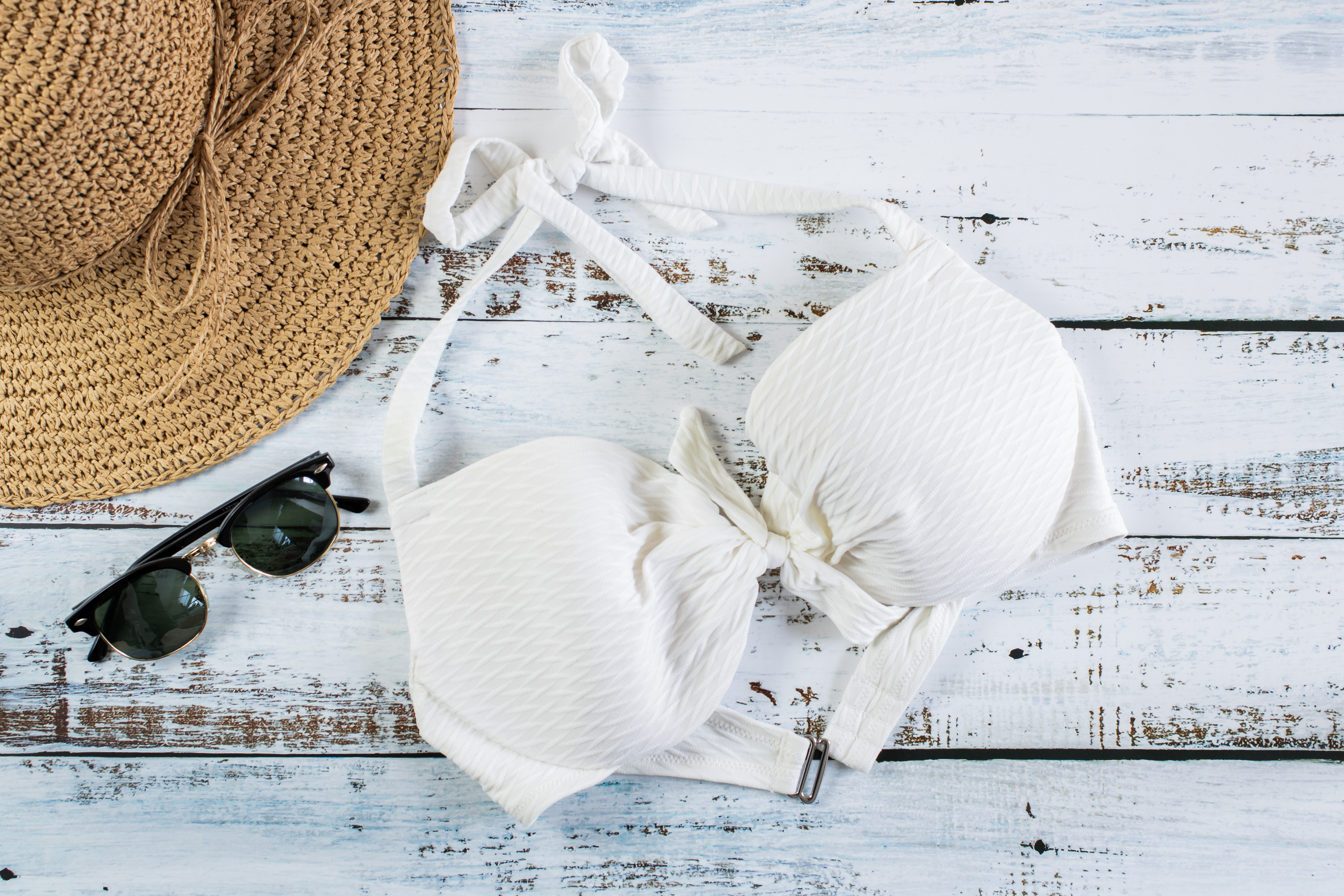 Free photo Women`s beach set with hat, swimsuit and sunglasses