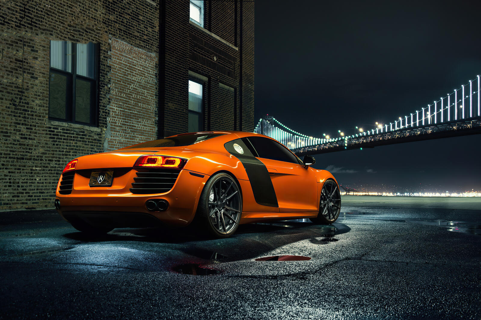 Бесплатное фото Оранжевая Audi R8 вид сзади на фоне ночного моста