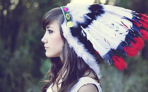 A girl in an Indian headdress.